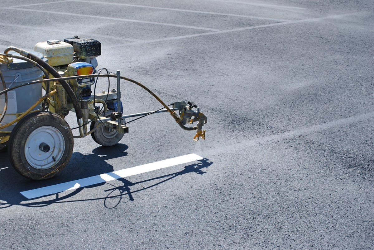 Striping machine painting crisp, freshly painted parking lot lines